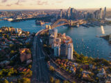 A photograph of the Sydney skyline in Australia showing the Sydney Harbour Bridge and Circular Quay.