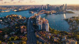 A photograph of the Sydney skyline in Australia showing the Sydney Harbour Bridge and Circular Quay.