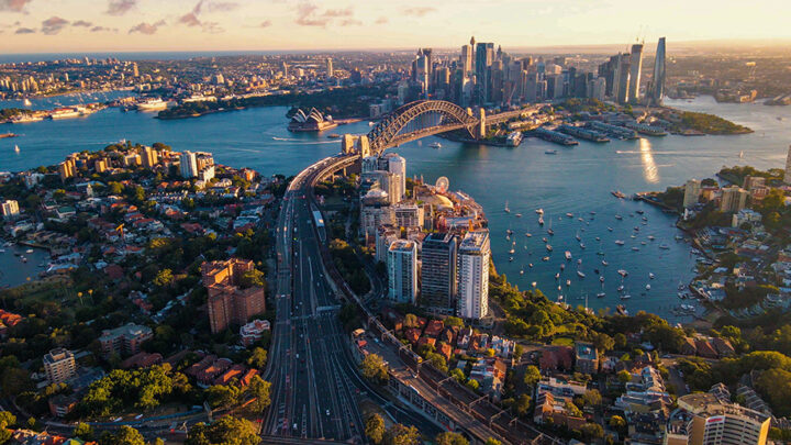 A photograph of the Sydney skyline in Australia showing the Sydney Harbour Bridge and Circular Quay.